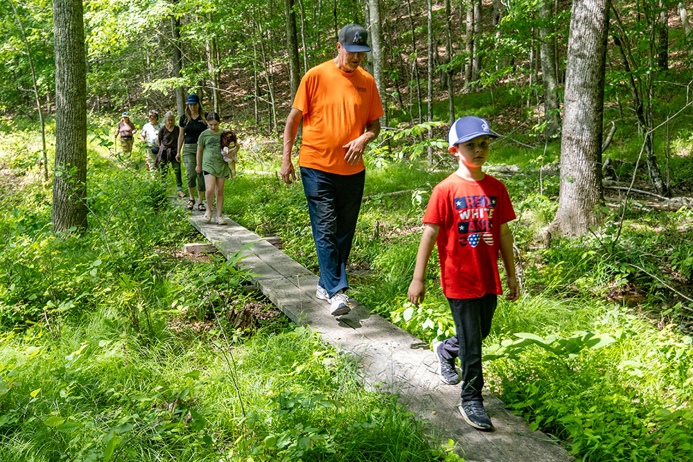 Hikers walk along the Killingworth Reservoir Trail